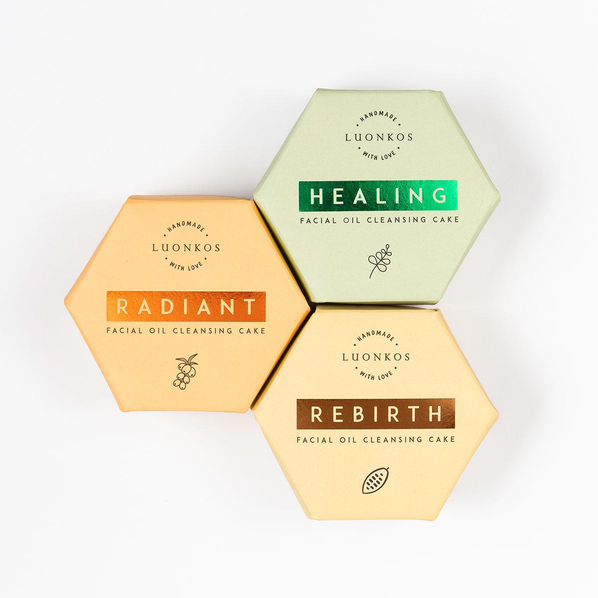 Hexagonal packaged Finnish Luonkos facial oil cleansing cakes in green, orange, and beige, eco-friendly skincare with öljypuhdistus metodi.