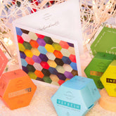 Colorful hexagonal Luonkos Lahjakortti gift card with natural cosmetics packaging and decorative lights background