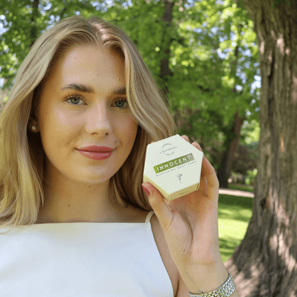 Young woman holding Luonkos Innocent soothing foot cake for sensitive skin natural care outdoors