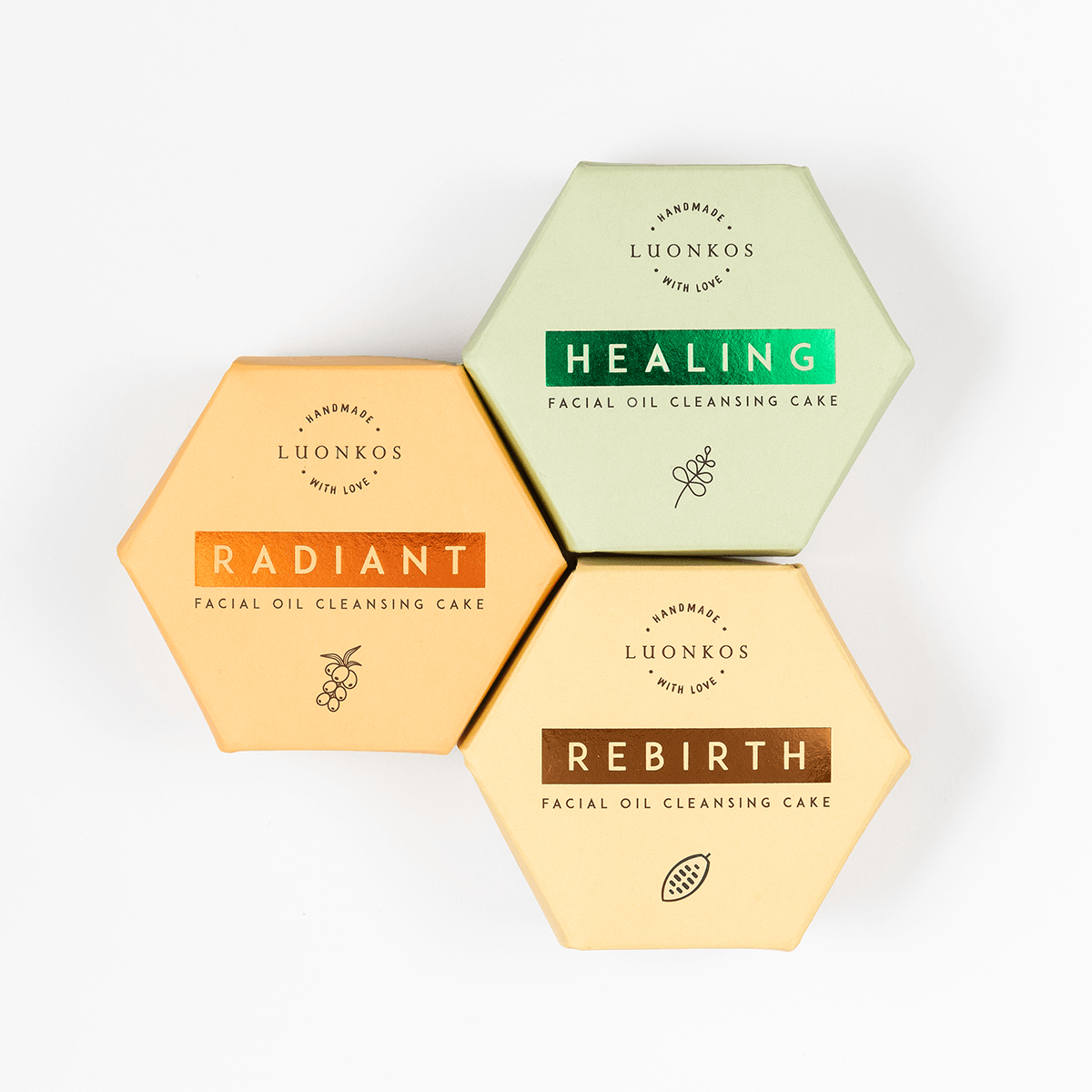 Hexagonal packaged Finnish Luonkos facial oil cleansing cakes in green, orange, and beige, eco-friendly skincare with öljypuhdistus metodi.