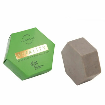 Vitality balancing body oil cake by Luonkos with hexagonal green packaging and solid body oil bar for moisturizing and soothing sensitive skin